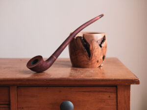 Old toby, churchwarden pipe made of briar and maple. Still life photo.