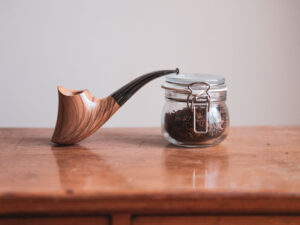 Volcano pipe made of apulian olive wood. Still life photo.